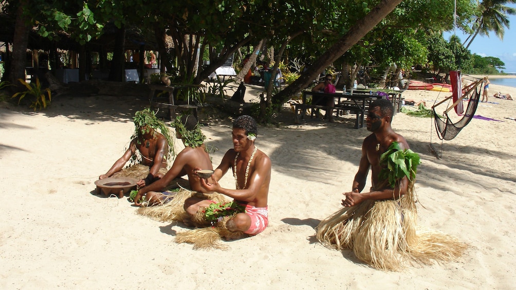 Show item 5 of 5. tribesmen resting at the beach at Robinson Crusoe Island in Fiji