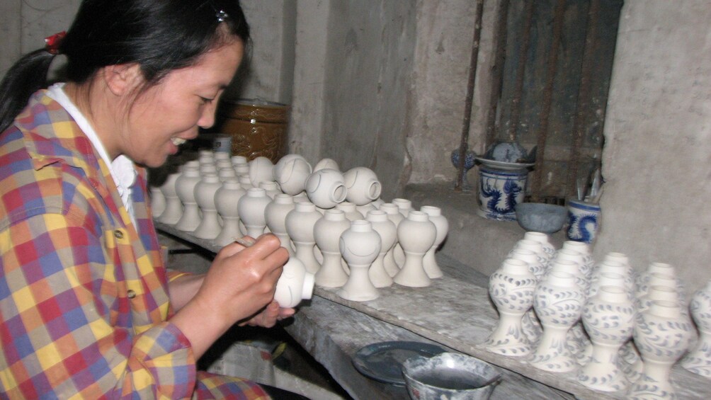 woman painting pottery in Vietnam