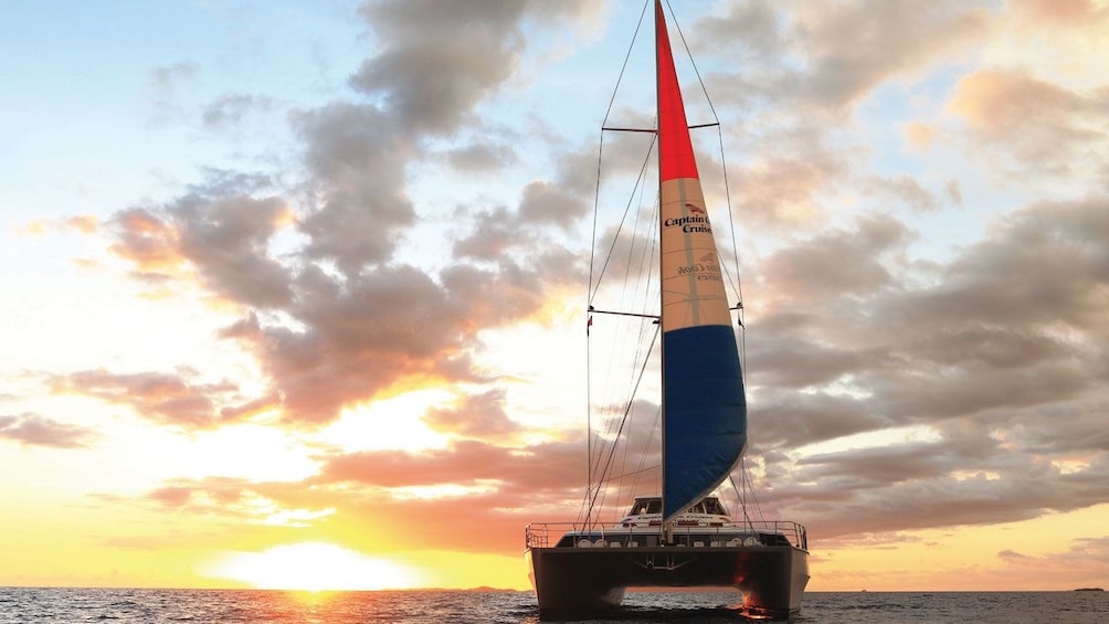 Catamaran sailing at sunset in Fiji