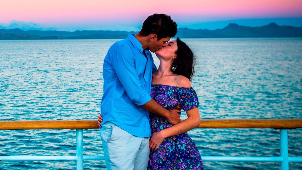 couple sharing a romantic kiss on a cruise in Fiji