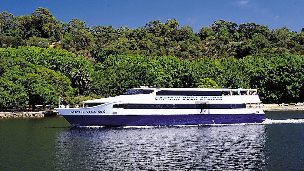 a cruise ship sailing up a river in Fremantle