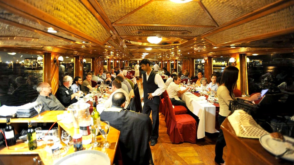 guests on boat eating dinner in Abu Dhabi