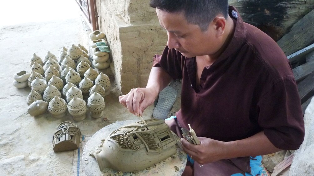 Artist working on ceramic creations in Vietnam