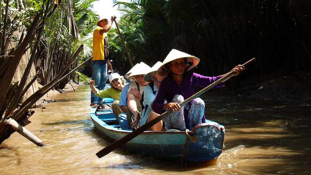Tourists on a scenic river cruise along the beautiful Mekong River in Vietnam 
