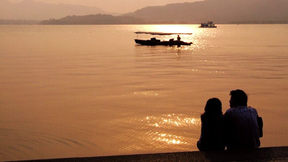 Beautiful sunset view of a couple enjoying the sunset view in Hangzhou