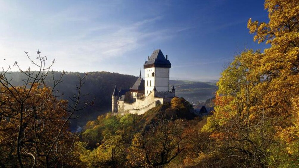 Karlstejn Castle perched on a hilltop with valley in the distance in the Czech Republic