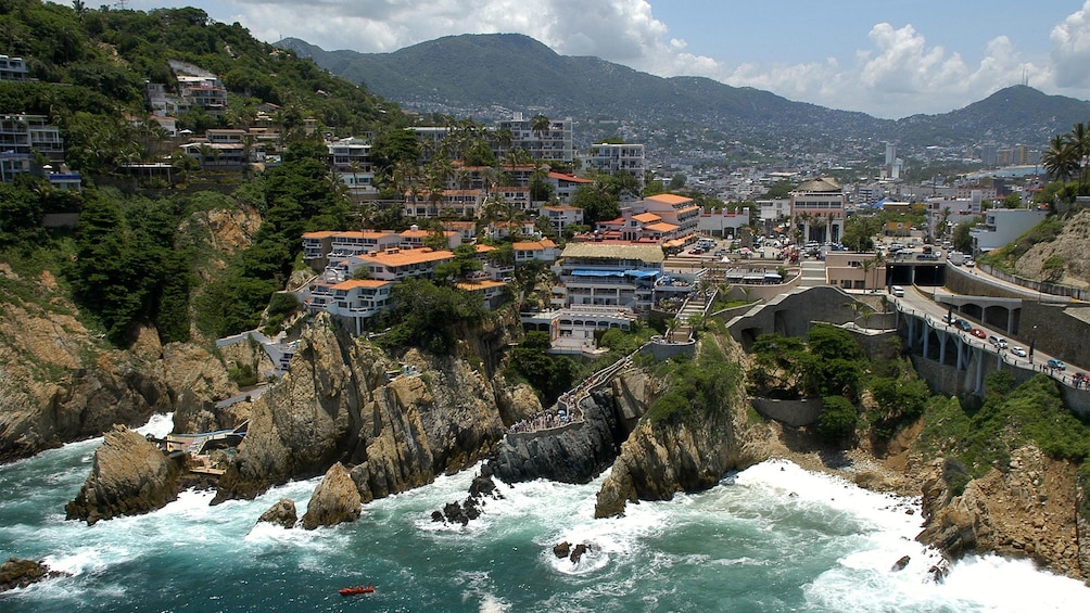 Rocky coastline and city of Acapulco