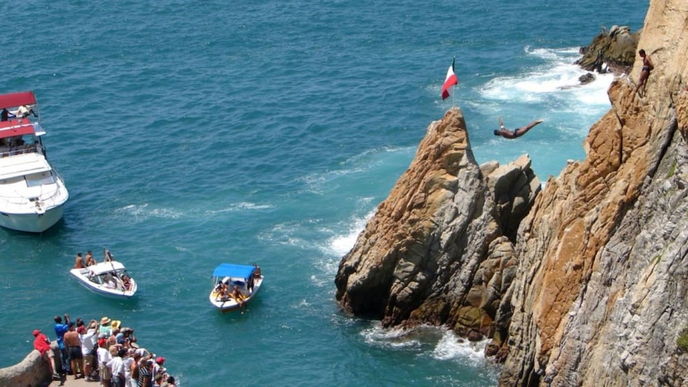 Group watching a cliff diver in Acapulco