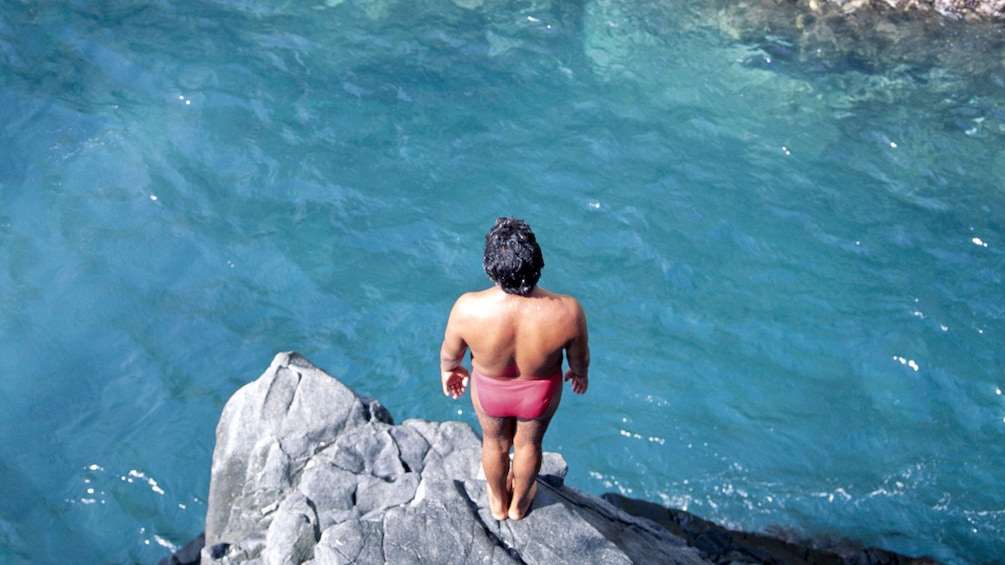 Man about to dive into crystal clear waters in Mazatlan