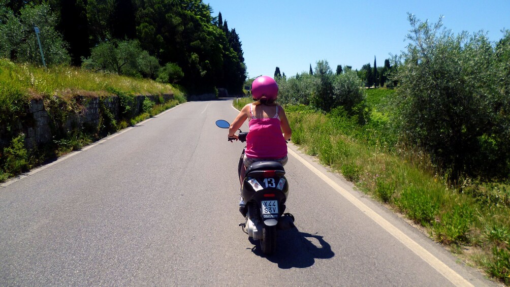 Girl on Road on Tuscany by Vespa tour in Italy