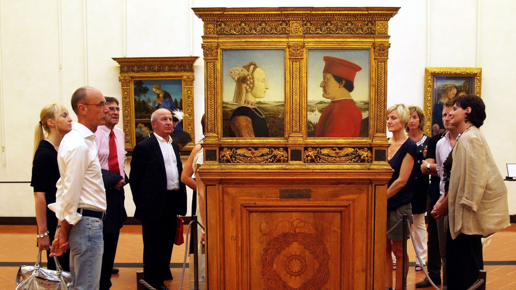 Group viewing paintings on Vasari Corridor and Uffizi Gallery Tour in Florence Italy