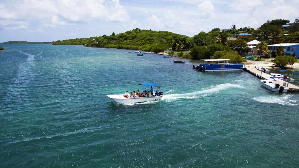 Show item 3 of 5. boat heading out from dock in Antigua