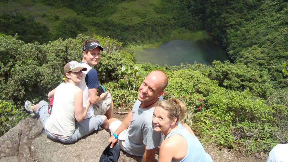 Hiking group sitting on top of Mount Liamuiga volcano in St Kitts