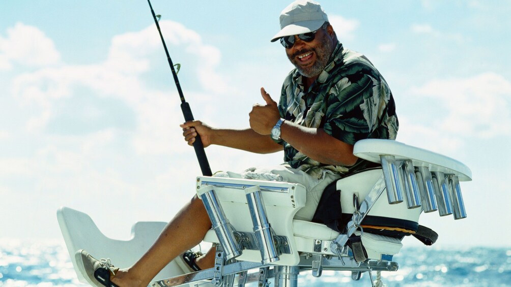 Deep sea fishing man gives a thumbs up on a boat in St Kitts