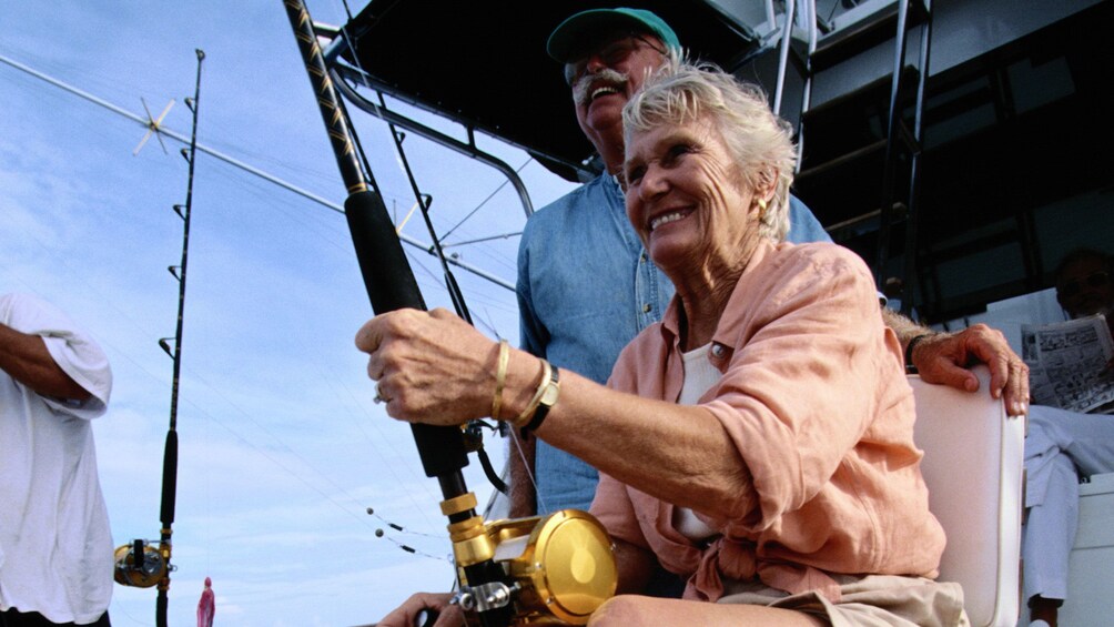 Woman holding a deep sea fishing pole on a boat in St Kitts