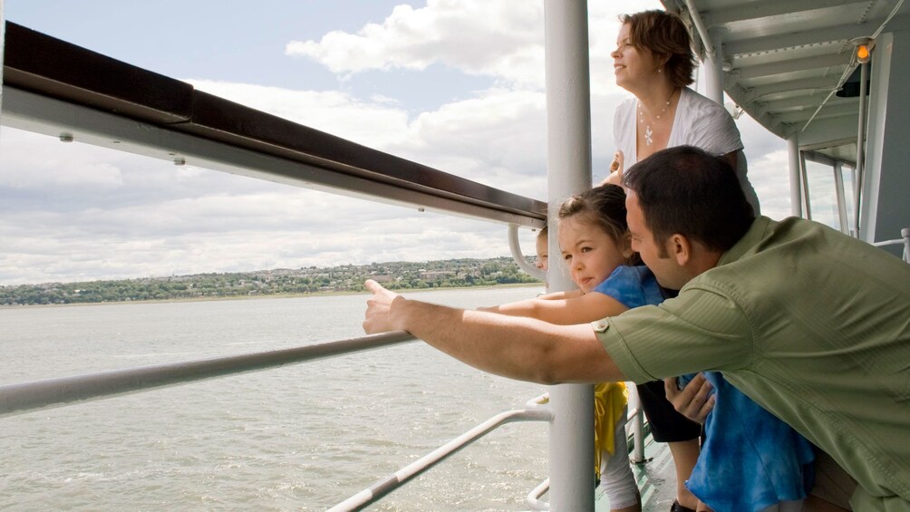 Family sightseeing onboard the Louis Jolliet river boat touring through the Saint Lawrence River