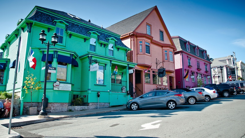 View of three buildings in green orange and magenta on one of the seaside towns in Nova Scotia Canada 