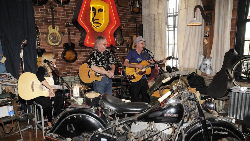 Musicians performing inside a rock themed room