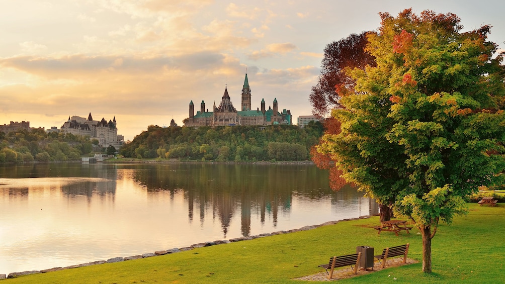 The Ottawa River and Parliament Hill in autumn at dusk in Ottawa