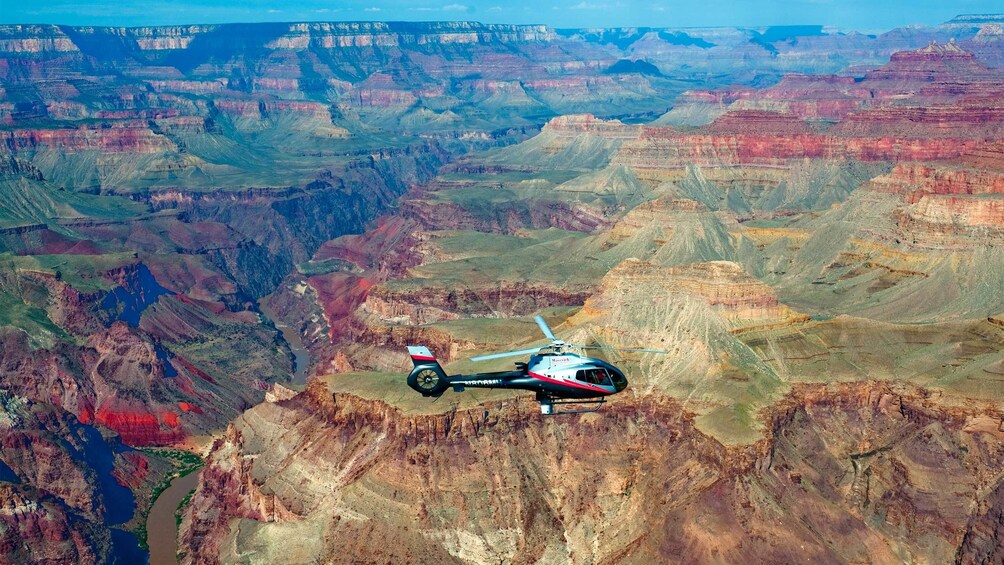 Scenic view of a helicopter flying above the Grand Canyon 