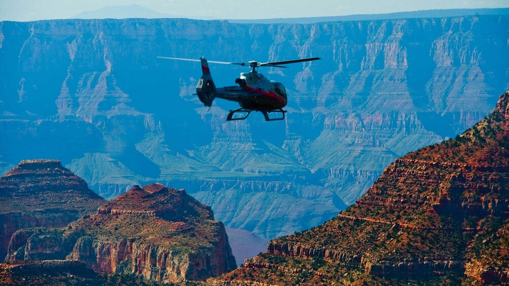 Helicopter flying over the Grand Canyon during the day 