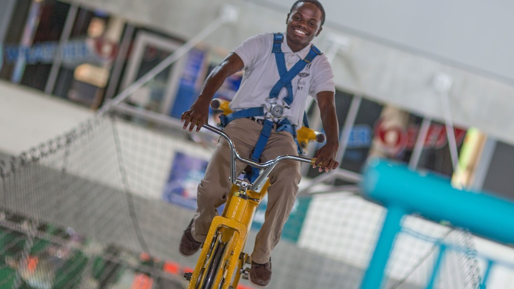 Man riding a bicycle in the Museum of Science and Industry