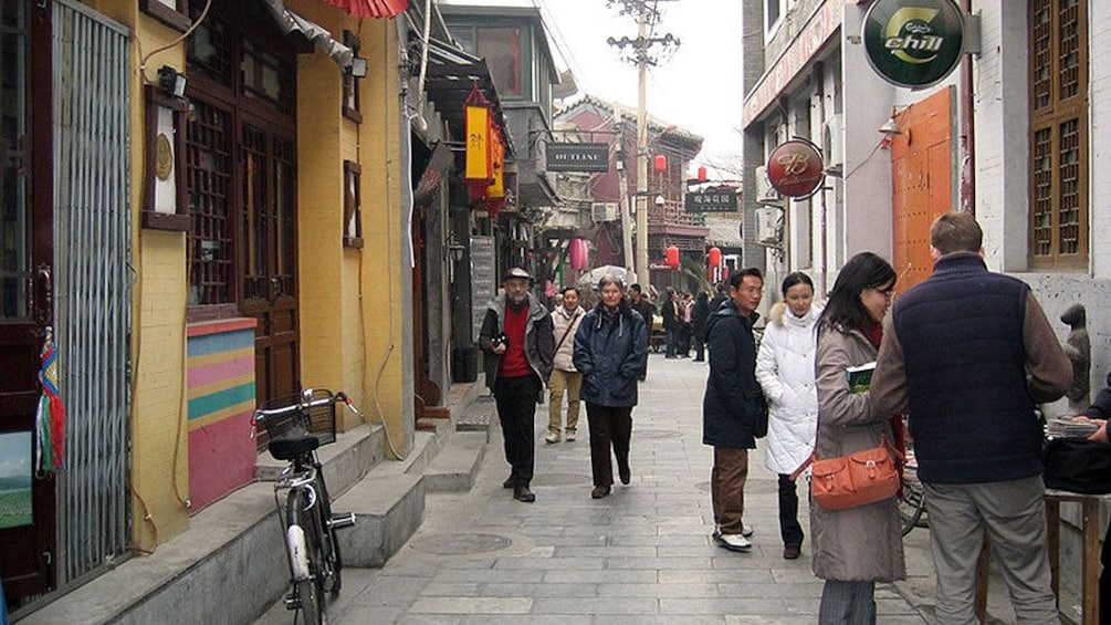 Locals and visitors on a narrow street in Beijing