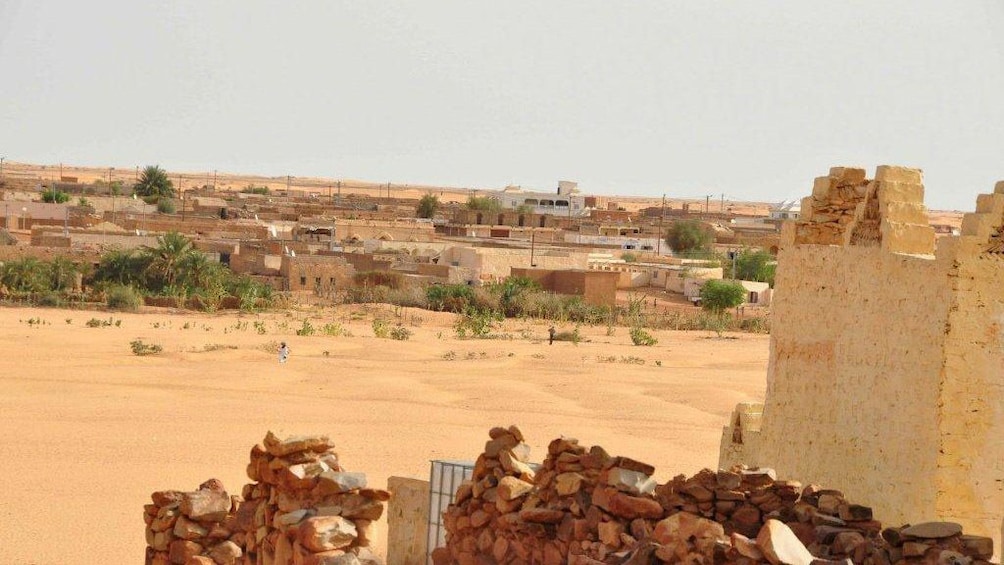 Stone ruins with city in the background in Ouarzazate