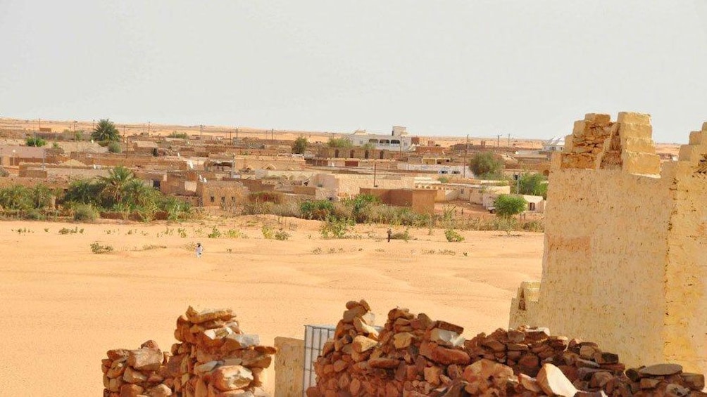 Stone ruins with city in the background in Ouarzazate