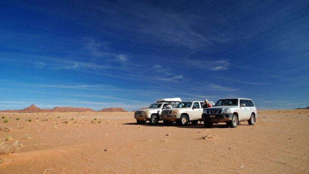 Three SUV's parked in the desert in Marrakech