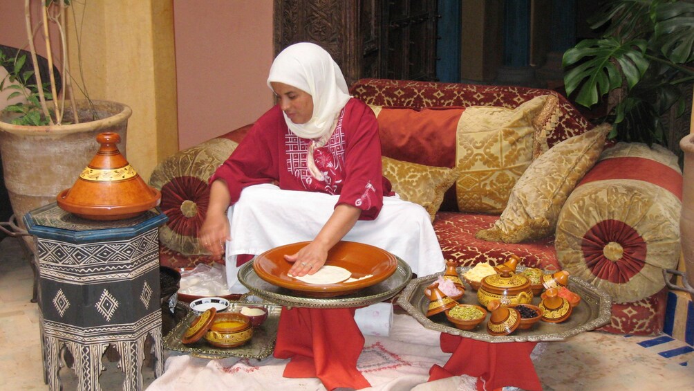 Woman flattening dough by hand in Marrakech
