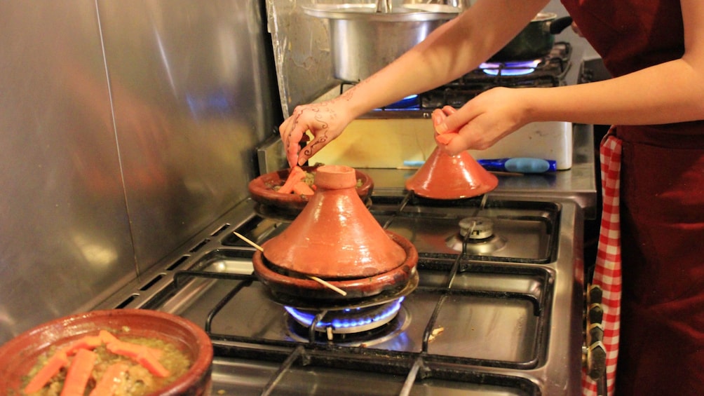 Terracotta pots with lids on a stove top in Marrrakech