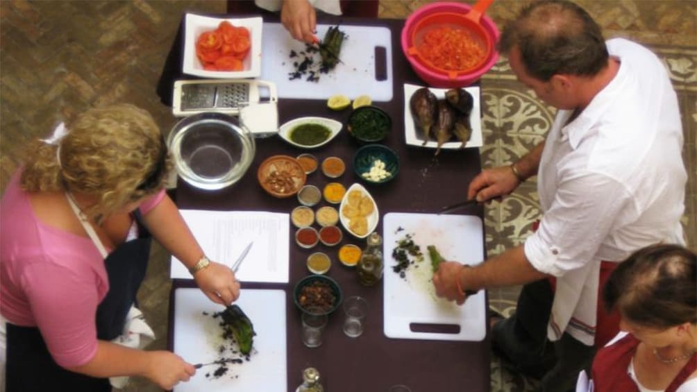Group chopping and preparing ingredients in a cooking class in Marrakech