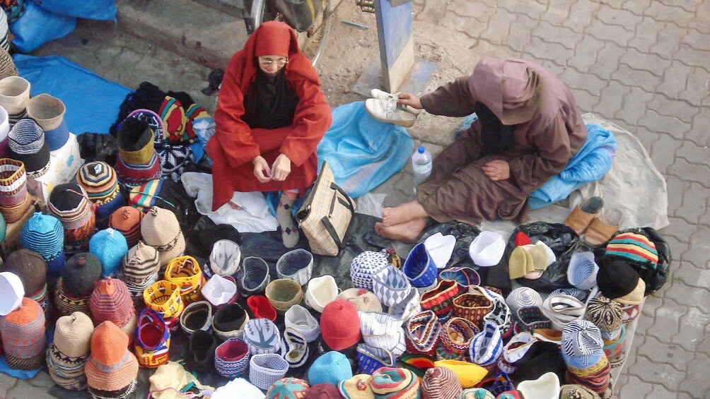 Vendors with handwoven crafts at a market in Marrakech