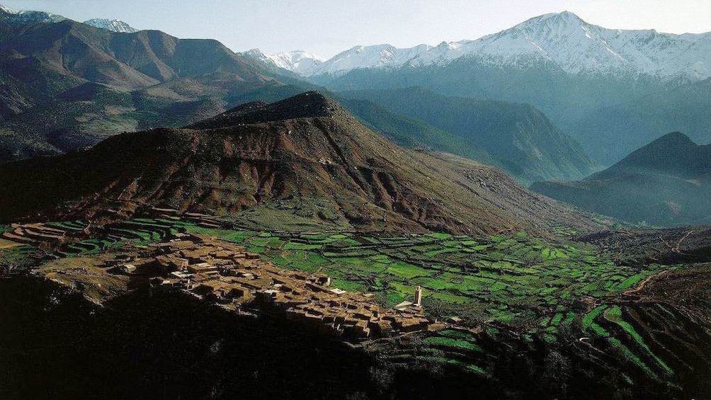 Lush green foothills of the snow-topped Atlas Mountains in Ourika