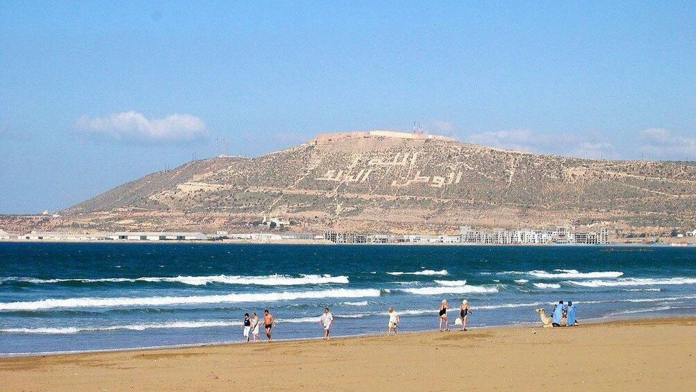 People walking along the beach on the coast of Agadir