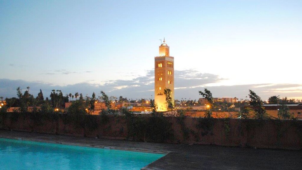 Koutoubia Mosque tower lit up at dusk in Marrakech