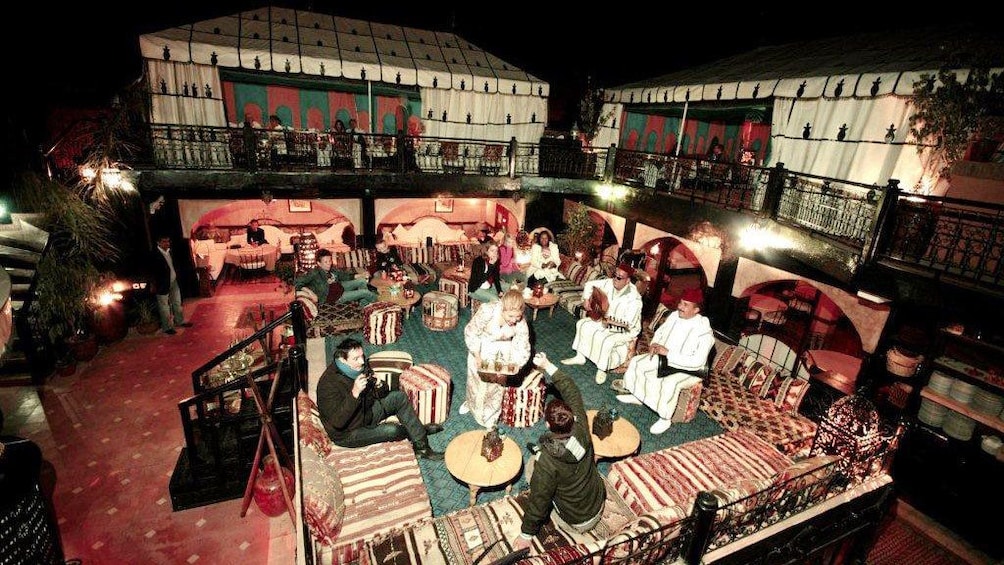 People enjoying beverages with live music outside at a restaurant in Marrakech