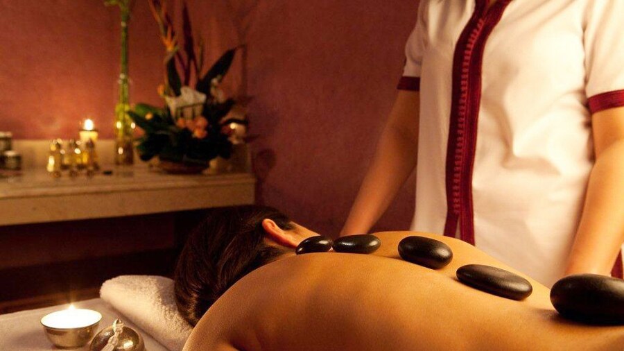 Woman with stones on her back during a massage in Marrakech