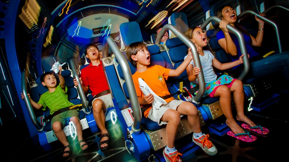 Adults and children in a 4D theater experience at Kennedy Space Center