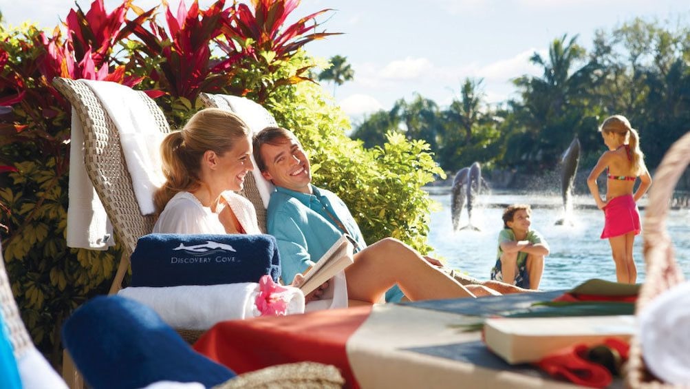 Show item 5 of 12. Lounging couple by the pool in Orlando.