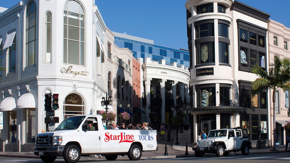 Starline tour bus driving past stores in Los Angeles. 