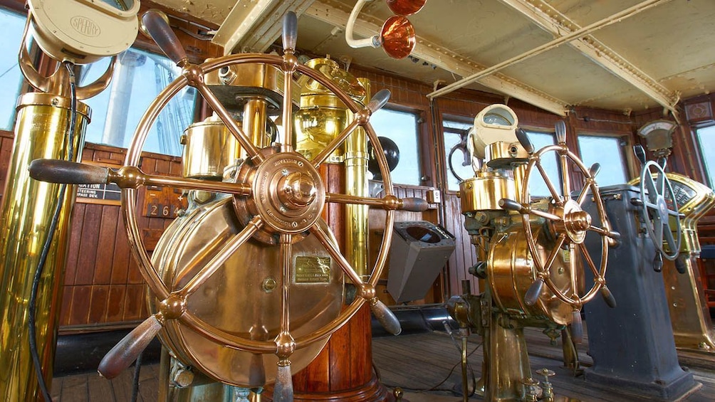 Show item 3 of 5. Copper and brass ship's wheels on the Queen Mary.