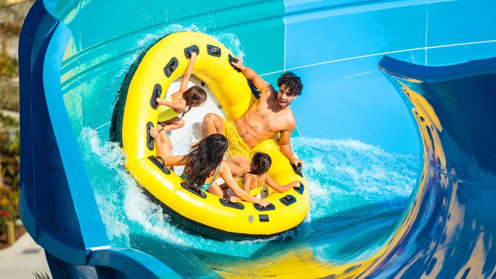 Close up of a Family on a wedge raft on a waterslide