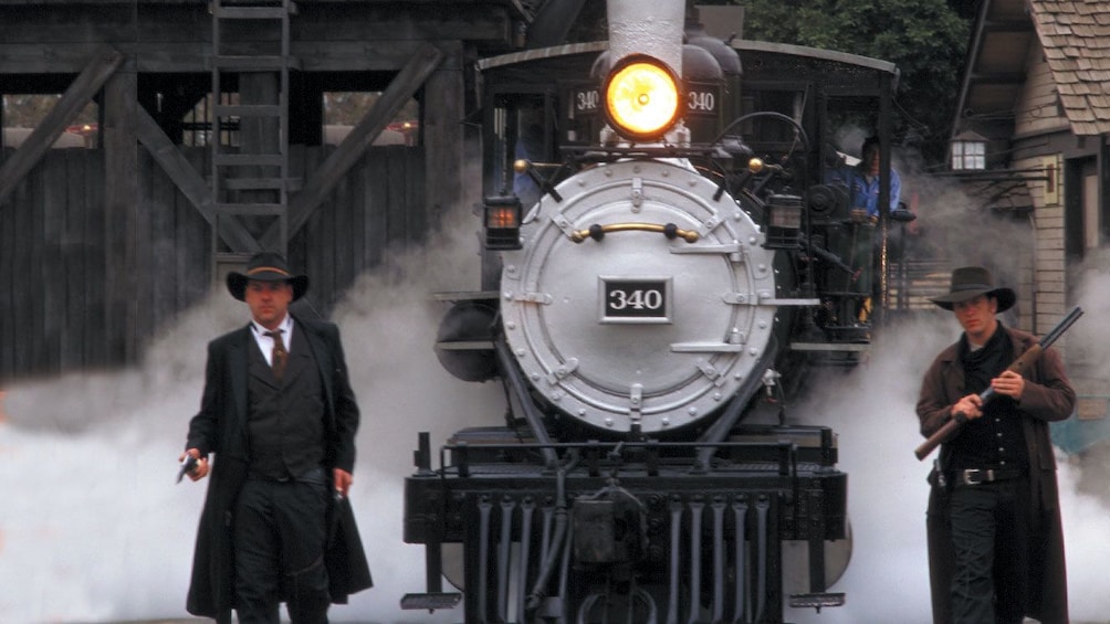 Two western gunslingers guarding a train at Knotts Berry Farm theme park in California. 