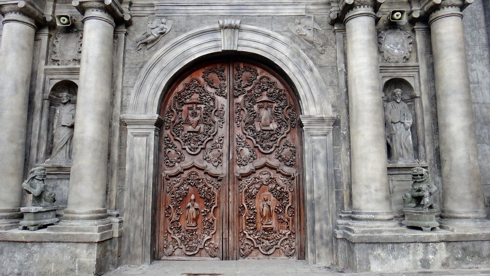 View of large carved doors of cathedral in Manila