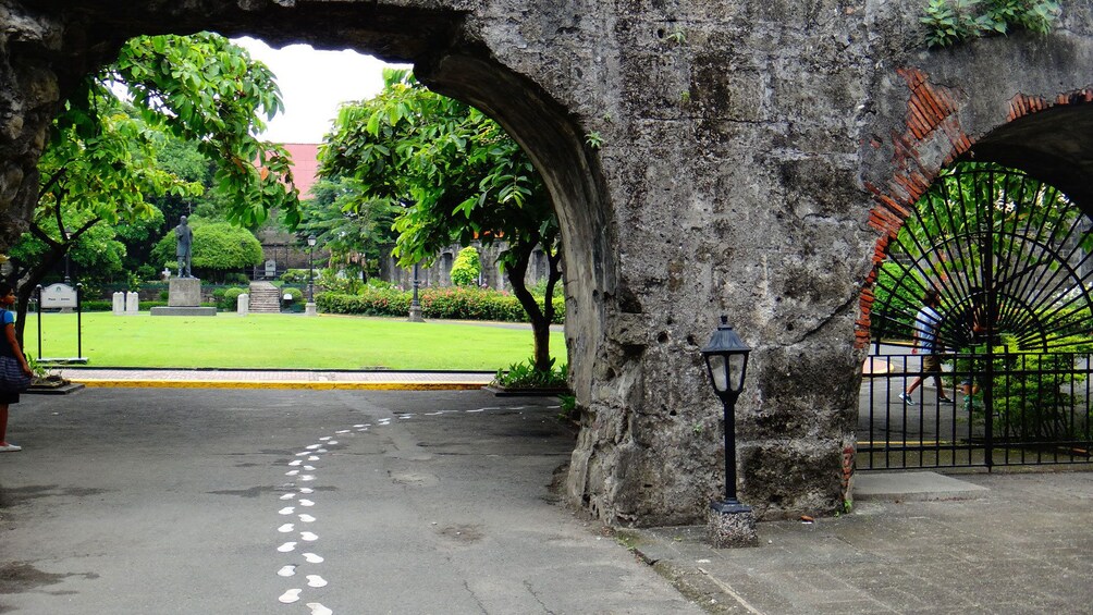 Road passing underneath old archway in Manila