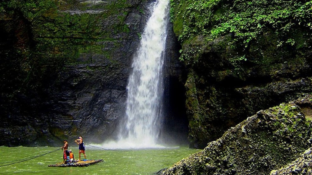 Bamboo raft near Pagsanjan Falls with Devil's cave behind