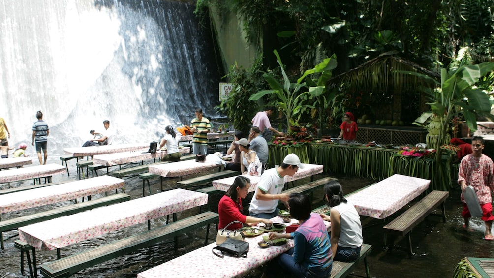People enjoying buffet in waterfall in Manila