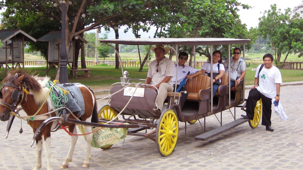 Las Casas Filipinas Resort guests in a horse-drawn carriage in Manila